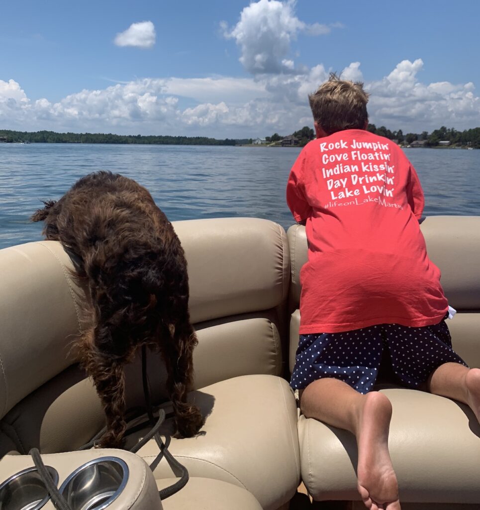 Dog and young man on boat