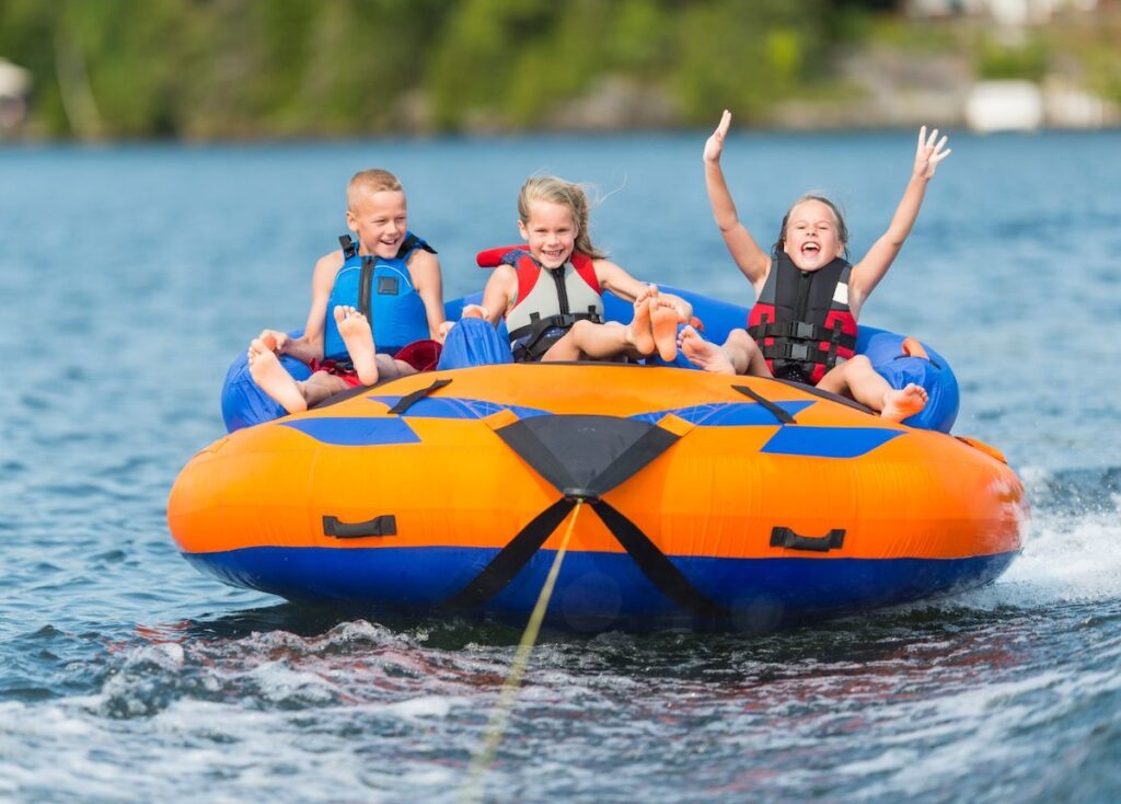 Kids on a towable tube on a lake