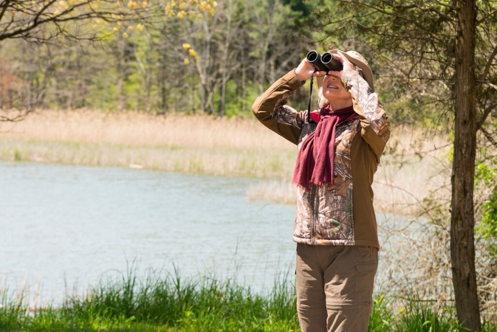 Woman with binoculars birding