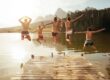 Friends jumping from the pier together