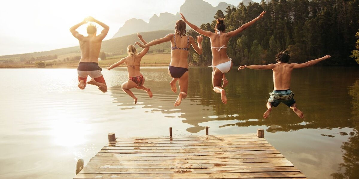 Untitled design – 2 Friends jumping from the pier together