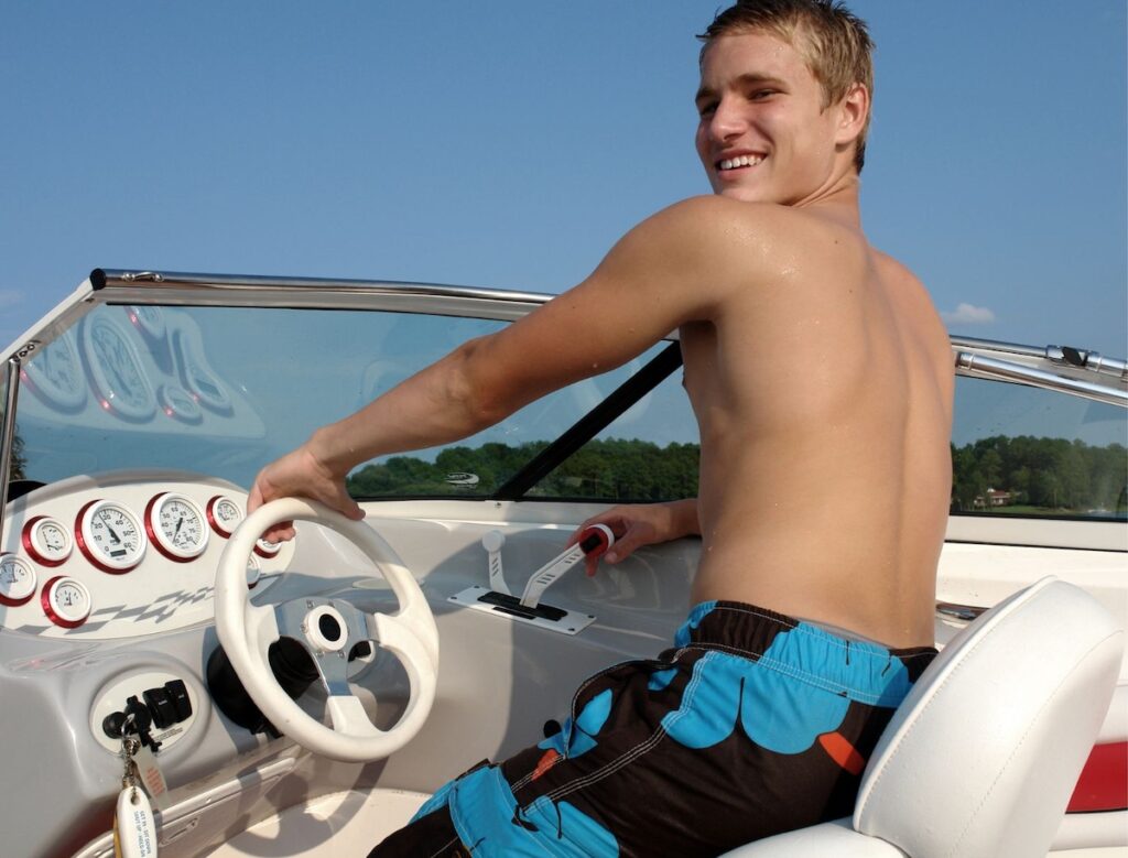 Young man driving a boat