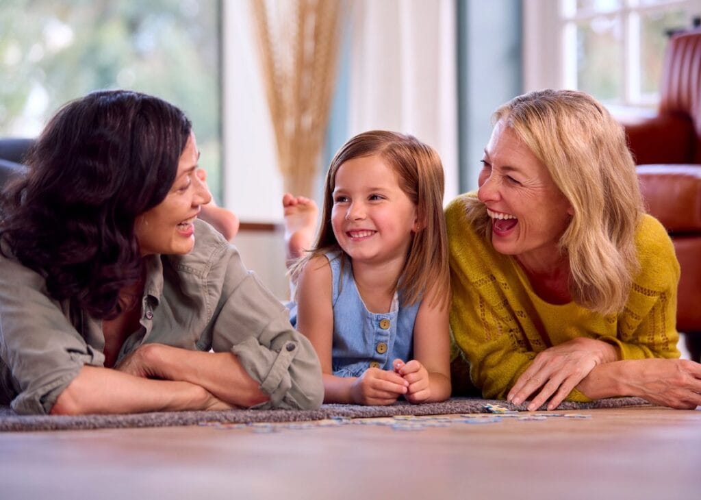 Two women and a girl with jigsaw puzzle